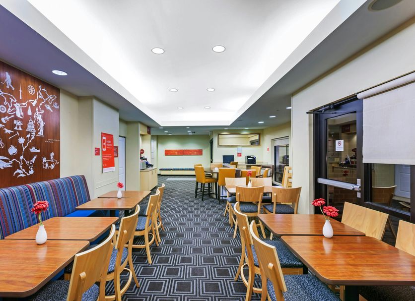 TownePlace Suites by Marriott Tulsa North/Owasso breakfast area in Owasso with tables, chairs, and booths