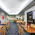 TownePlace Suites by Marriott Tulsa North/Owasso breakfast area in Owasso with tables, chairs, and booths