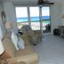 Pelican Beach Resort & Conference Center in Destin with ocean-view balcony and beach visible from living room