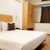 The Unicontinental - Campus Accommodation room in Mumbai with bed, desk, wardrobe and mirror