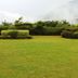 Hotel Devi Grand in Katra: landscaped lawn with trimmed hedges and misty mountain views