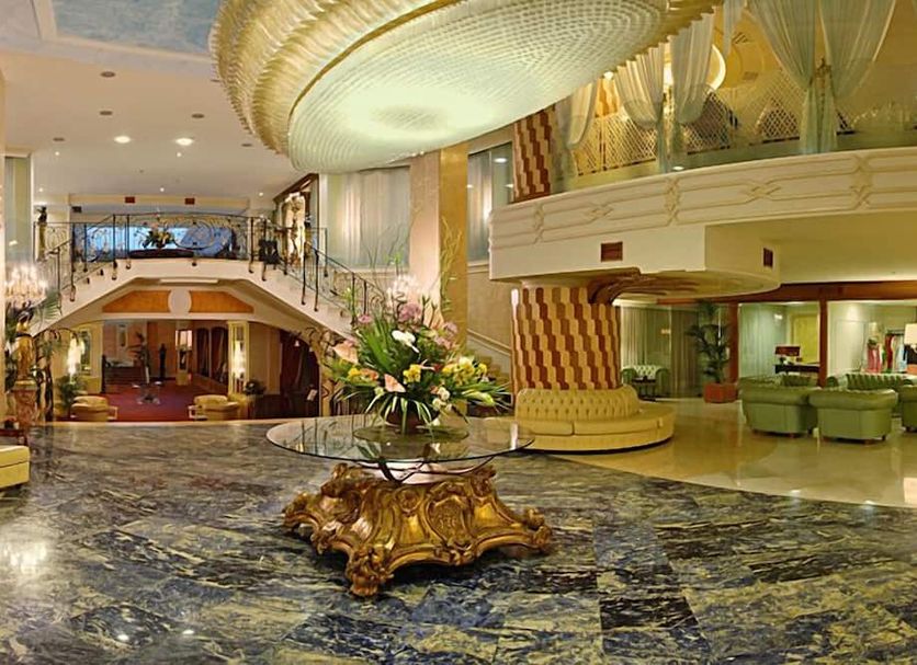 Grand Hotel La Pace in Sorrento lobby with ornate chandelier, marble floor and floral centerpiece