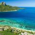 Barefoot Kuata Island on Kuata Island with turquoise bay, beach, and green mountain backdrop
