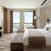 Langham Place, Xiamen room with king bed and ocean view through floor-to-ceiling windows