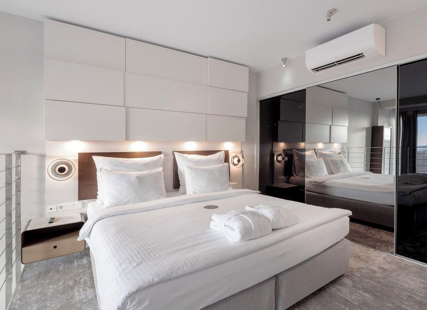Marine Hotel by Zdrojowa in Kolobrzeg, modern bedroom with king bed, mirrored wardrobe and balcony ocean view