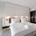 Marine Hotel by Zdrojowa in Kolobrzeg, modern bedroom with king bed, mirrored wardrobe and balcony ocean view