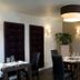 B&B Brasserie Lakerhof dining room in Ohe en Laak with set tables, black chairs, and wine storage