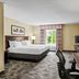Country Inn & Suites by Radisson Princeton, WV guest room with king bed, desk, TV and window view