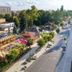Hotel Barátság in Hajdúszoboszló with colorful outdoor terrace and tree-lined street view