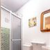 Pousada Soft Brooklin bathroom in Sao Paulo with shower, toilet, sink and wall mirror