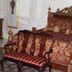 Dansereau House in Thibodaux: ornate antique bedroom with carved wood bed and upholstered bench
