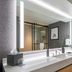 Sheraton Nashville Brentwood bathroom with double vanity, large lit mirror, and walk-in shower in Brentwood