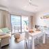 Onslow Beach Resort in Onslow room with sea-view balcony, dining table and sofa