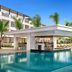 Secrets Tides Punta Cana in Uvero Alto, poolside swim-up bar beside a large resort pool and loungers