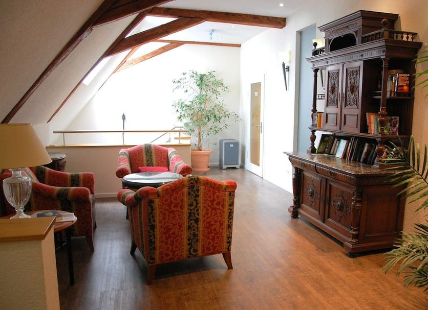 Bodensee-Hotel Kreuz lounge in Uhldingen-Mühlhofen with wood beams, seating area and cabinet