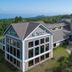 Black Beach Inn by GrandStay in Silver Bay, exterior with lake view and forested backdrop