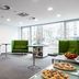Park Inn by Radisson Frankfurt Airport breakfast area with green seating and large windows in Frankfurt am Main