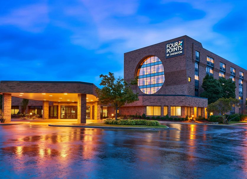 Four Points by Sheraton Milwaukee North Shore in Brown Deer, exterior at dusk with wet pavement reflections