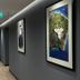 Mulaj Hotel in Tirana hallway with framed art, recessed ceiling lights, and exit sign