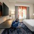 Fairfield Inn & Suites by Marriott Brunswick Freeport guest room with king bed, desk, chair and window