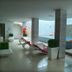 Meshal Hotel & Spa in Manama: indoor pool and spa area with lounge chairs, steps, and green wall