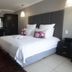 Ruslamere Hotel and Conference Centre in Durbanville: modern guest room with king bed, desk, wardrobe and hanging lights