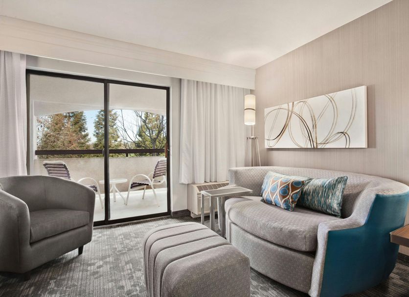 Courtyard by Marriott San Jose South/Morgan Hill guest room with balcony and seating area