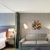 Home2 Suites by Hilton Tampa - USF/Near Busch Gardens guest room with sofa, lamps and artwork