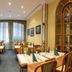 Galerie Hotel Leipziger Hof in Leipzig restaurant with set dining tables and wooden chairs