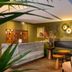 Hôtel Aoriste & Spa Paris lobby with marble reception desk, seating area and decorative wall art