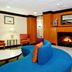 Fairfield Inn & Suites by Marriott Fairfield Napa Valley Area lobby with fireplace seating and blue curved sofa