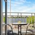 Hotel Nysted Havn balcony with table, two chairs, and harbor view in Nysted