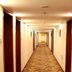 Haowei Mansion in Beijing hallway with patterned carpet and doors along a long interior corridor.