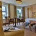Westville Hotel Enniskillen guest room with king bed, seating area and large windows