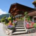 Haus Sonnwend in Alpbach with flower-lined stone steps and alpine chalet balconies