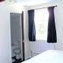 The Green Man Rugby guest room with open ensuite bathroom and window with dark curtains