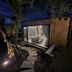 EcoResort Il Cantico della Natura in Magione, lit eco cabin with glass doors and stone path at night