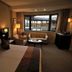 Xiang Ming Holiday Hotel in Huangshan guest room with large window overlooking a pool and lounge seating