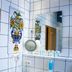 Hotel Vier Jahreszeiten Volkach bathroom with tiled walls, sink, mirror, hair dryer and floral tile art