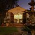 La Mirage Garden Hotel And Spa in Cotacachi with lit courtyard entrance and decorative fountain at dusk