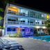 Sarges Hotel in Serrekunda with illuminated outdoor pool and three-story balcony facade at night