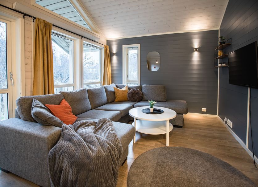 Tromsø Lodge & Camping in Tromsø, cozy lounge with sectional sofa, coffee table, and large windows