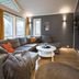 Tromsø Lodge & Camping in Tromsø, cozy lounge with sectional sofa, coffee table, and large windows