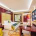 Shijiazhuang Shen Zhou 7 Star Hotel guest room with bed, desk, sofa and wall art in Shijiazhuang