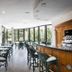 Balneari Termes Victòria in Caldes de Montbui: bright hotel lounge with bar, tables, and seating by windows