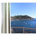 Hotel Plaza in Porto Azzurro with a balcony view of the bay, sailboats, and a coastal hillside
