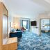 Hampton Inn ATL-Lawrenceville-I-85-Sugarloaf room with sofa, desk, TV and view into bedroom