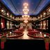 The Reserve at Park MGM in Las Vegas lounge with plush red seating, chandeliers, and dramatic library-style shelves
