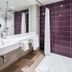 Premier Inn Stuttgart Airport bathroom with double sink, shower and purple tiled walls in Leinfelden-Echterdingen