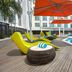 Kingsford Hotel Manila Bay in Manila with poolside loungers, orange umbrellas, and a waterfront pool